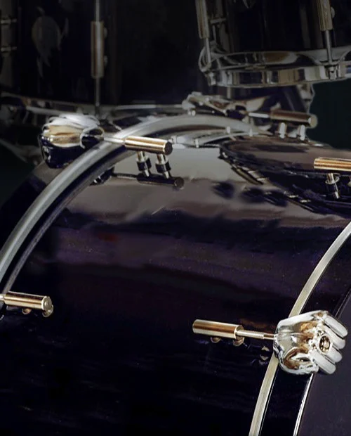 Chrome claw-shaped Cool Claws lugs attached to a bass drum rim
